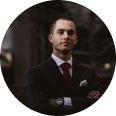 Man in suit with crossed arms.