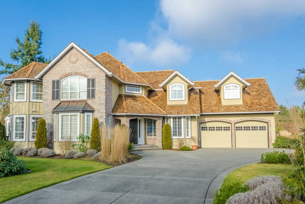 Large suburban house with a spacious driveway.