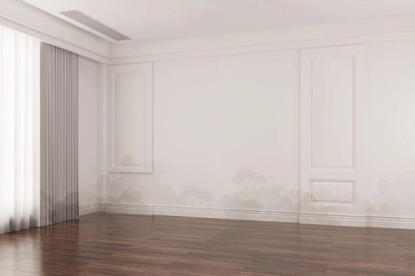 Empty room with wooden floor and curtains.
