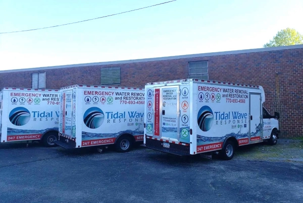 Tidal Wave Response emergency trucks parked outside.