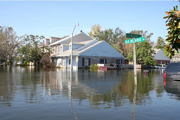 Flooded residential area with submerged street signs.