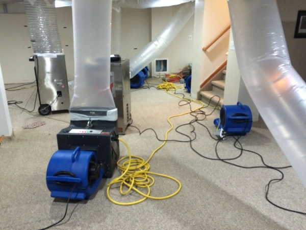 Basement with drying equipment and ventilation tubes.