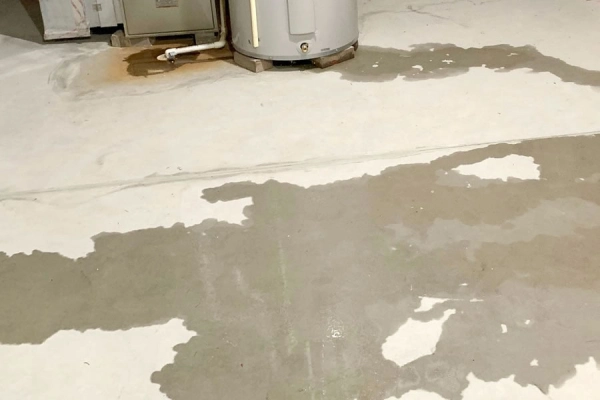 Water heater leak causing floor puddles.