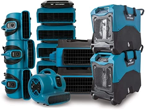 Blue industrial air movers and dehumidifiers stacked.